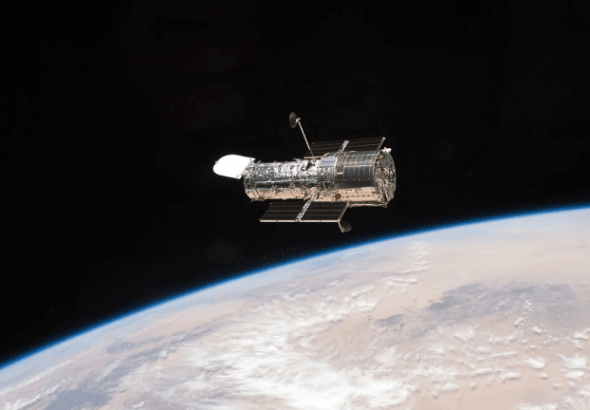 a figure eight in deep space hubble image shows gravity warping distant galaxies 768x432 1